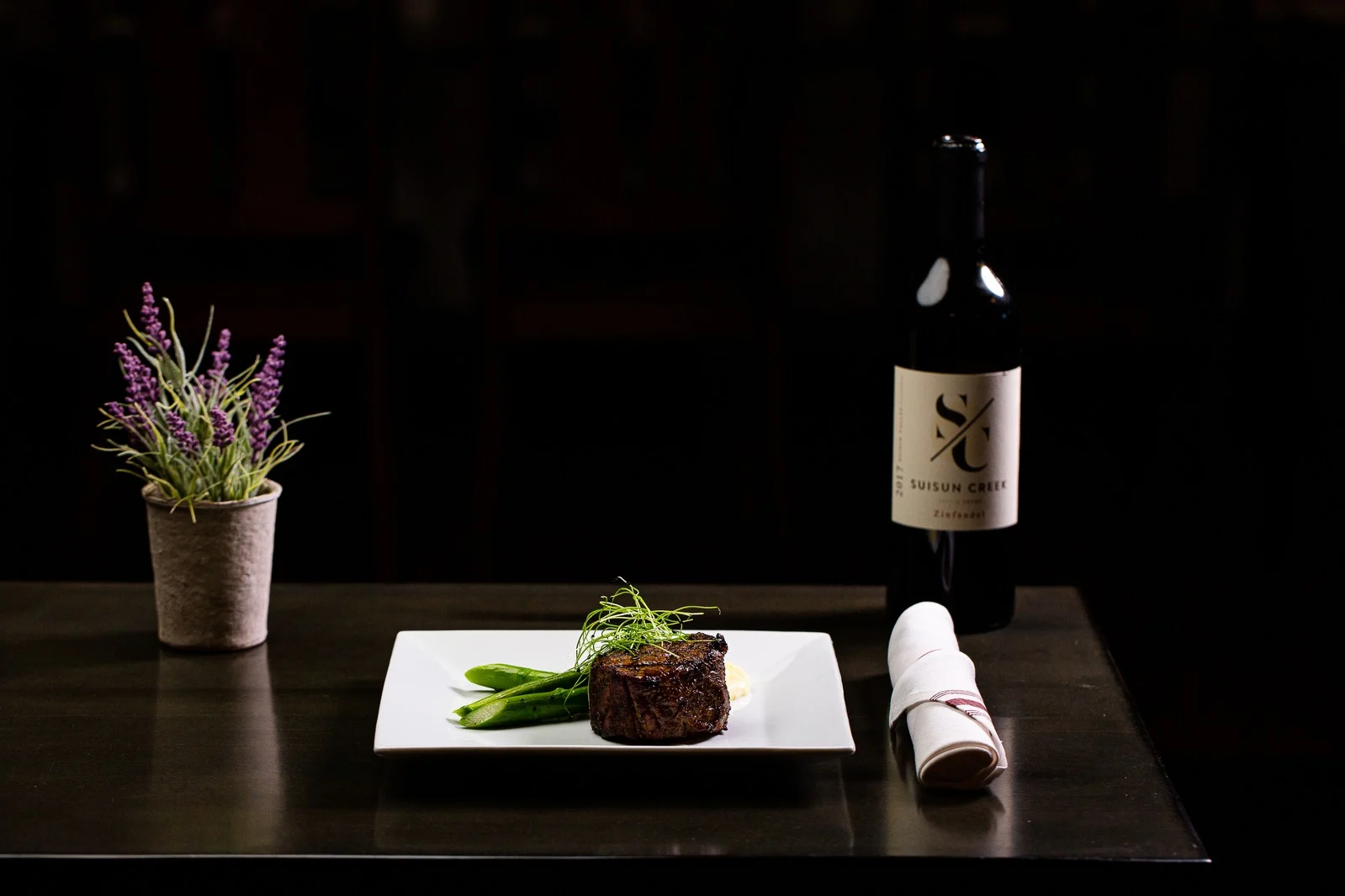 Wine bottle and plated entrée from Mankas Grill restaurant in Suisun Valley.