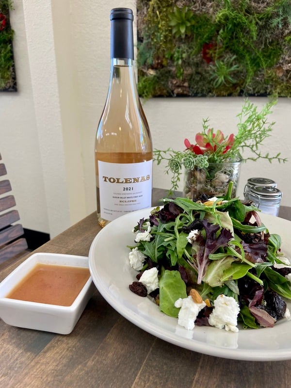 Plate of a prepared meal and Tolenas wine at Rockville Kitchen + Bar in Fairfield CA.